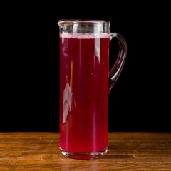 a glass of red compote on wooden table