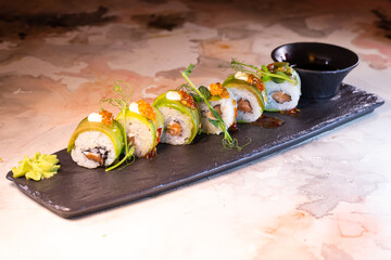 japanese dish rice rolls with cheese on a black plate