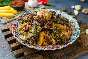 pilaf with beef and dolma on grey table