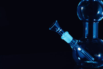 Closeup view of glass bong on black background, space for text. Smoking device