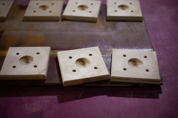 Detailed workpiece in carpentry workshop. Square made of plywood. Template for fastening. They made furniture production.