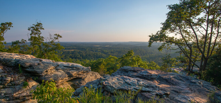 Shawnee national forest seen from a rocky precipice bathed in golden sunlight