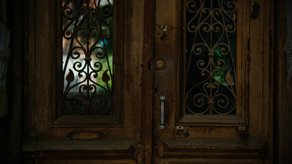  Lovely vintage door with light in its glass and a decorative lattice 