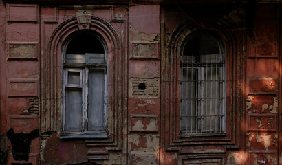 Two old european style windows with withered paint 