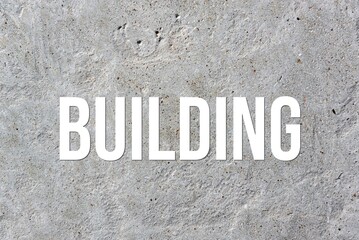 BUILDING - word on concrete background. Cement floor, wall.
