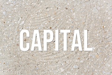 CAPITAL - word on concrete background. Cement floor, wall.
