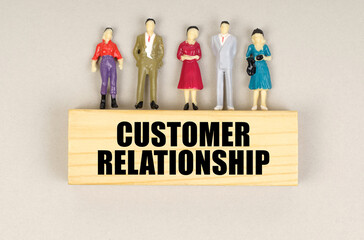 On the block with the inscription - Customer Relationship there are miniature figures of people.