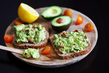 Guacamole sandwiches on a wooden board. Keto diet food.