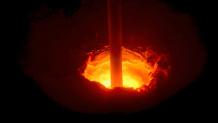 Close up of a hole in melting furnace with a rotating rod, metallurgical industry concept. Stock footage. Process of metal melting at the plant.