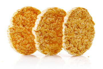 Caramelized corn cakes. Puffed whole grain crispbread isolated on white background. Close-up.