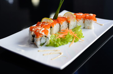 Sushi rolls on white dish. Japanese food.	