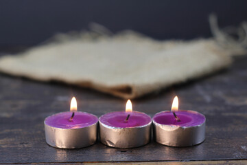 Obraz na płótnie Canvas burning candle photo studio gold light of purple candle
