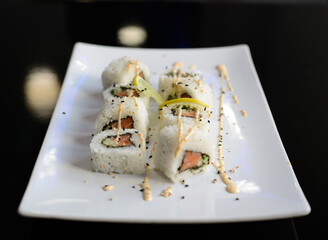 Sushi rolls on white dish. Japanese food.