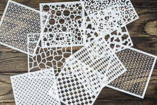 Various plastic stencils on table. Accessories and tools of the artist for drawing. Creativity and handcraft concept.