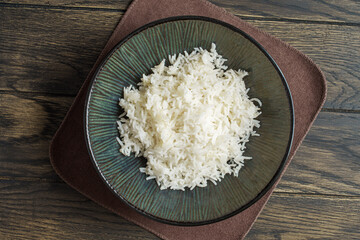 Cooked rice in a bowl on the table, top view