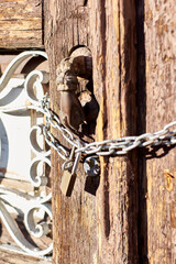Old door with knocker and chains