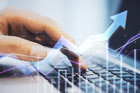 Close up of businessman hands using laptop with abstract growing business arrow and chart on blurry background with index grid. FInancial data, technology, trade and market concept. Double exposure.