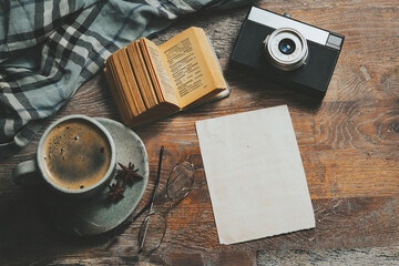 Outfit of traveler with cup of coffee on wooden background, Vintage style