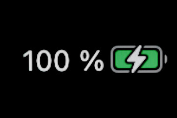 Smartphone charged battery level indicator - charging process - one hundred, 100 percent: close up,...