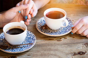 Cups with a coffee in the hands of men and women. Selective focus. Drink.