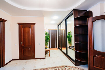 entrance hall with a large mirrored wardrobe and shoe cabinet. 