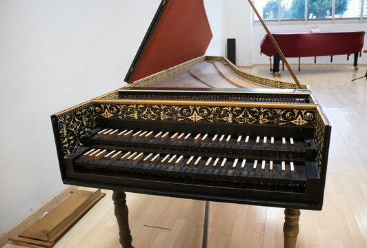baroque style harpsichord, old renaissance classic piano with black wooden keys