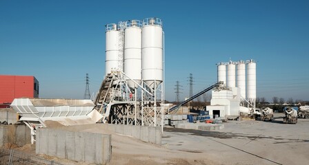 Scenery of concrete factory with white silos for production of concrete © Iwona