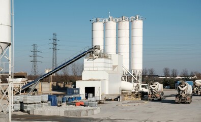 Scenery of concrete factory with white silos for production of concrete © Iwona