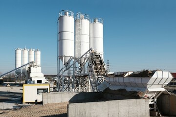 Scenery of concrete factory with white silos for production of concrete