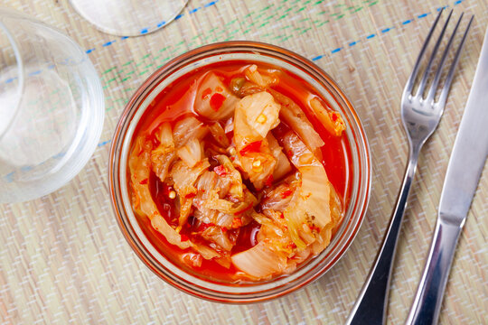 Appetizing vegetable salad kimchi of marinated napa cabbage seasoned with spicy red gochu pepper. Authentic Korean dish..