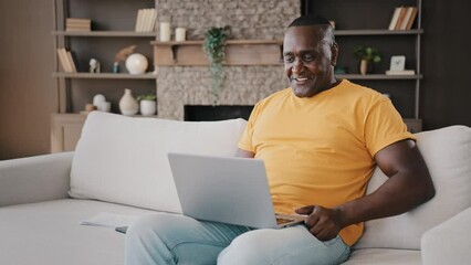 African senior businessman freelancer adult male american consumer man teacher coach talking to webcam video conference calling in virtual chat waving hand greeting friend remote friendly conference