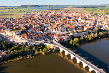 Aerial view on the old stone bridge of Douro river and old town Tordesillas. Spain © JackF