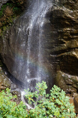 alpinist climbing down a waterfall