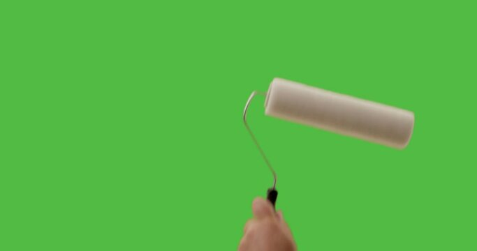 Male Using Paint Roller Two Strokes Across Green Screen.