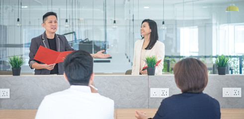 Business team training in progress, with trainers and trainees in a co working space.