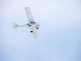 Flight Design CTSW. Zoom photo of small propeller airplane landing to small airport