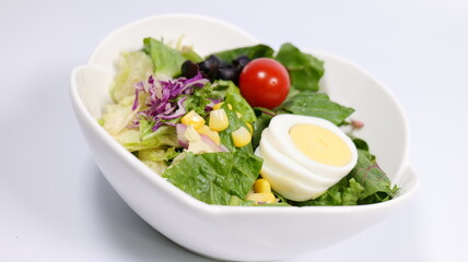 Salad topped with tomatoes and eggs