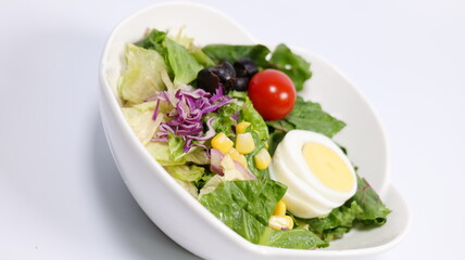 Salad topped with tomatoes and eggs