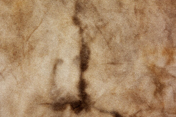 Old fabric with brown stains full frame for background, murder case idea, old blood stains on fabric,cream brown abstract