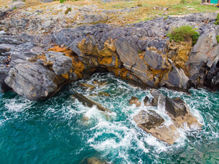 Aerial view seashore wave on rocky cliff
