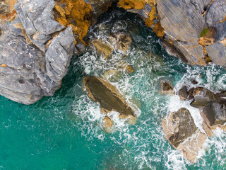 Aerial view seashore wave on rocky cliff