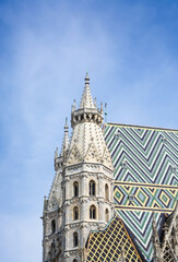 Fototapeta na wymiar Top view of the towers of St. Stephen's Cathedral, Stephansdom in Vienna against the blue sky