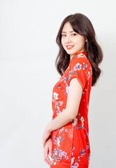 Portrait of beautiful young asian woman wearing traditional cheongsam qipao dress isolated on white background.
