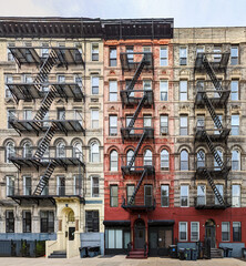 Exterior view of old apartment buildings with fire escapes in the East Village neighborhood of New...