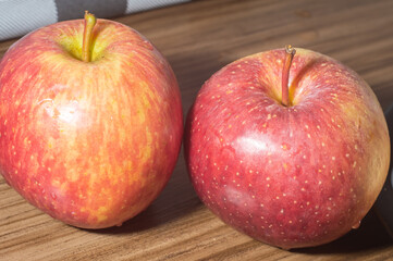Breads and apples on a wooden tablet with copy space and soft light