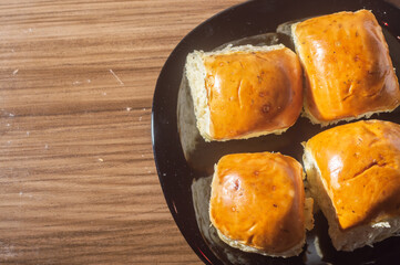 Breads and apples on a wooden tablet with copy space and soft light