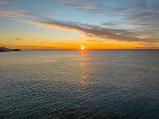 Fototapeta na wymiar Sunrise over the sea with high cloud