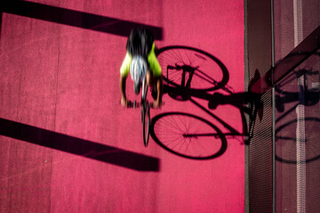 Motion blur cyclist riding fast on a pink cycle path cycleway - obrazy, fototapety, plakaty