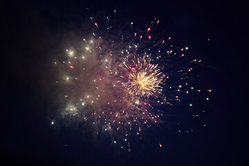 multicolored lights of fireworks exploding in the night sky