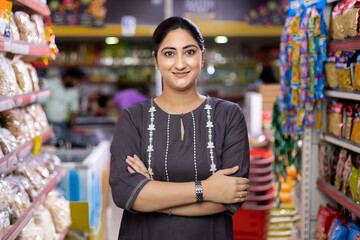 Woman in grocery aisle of supermarket